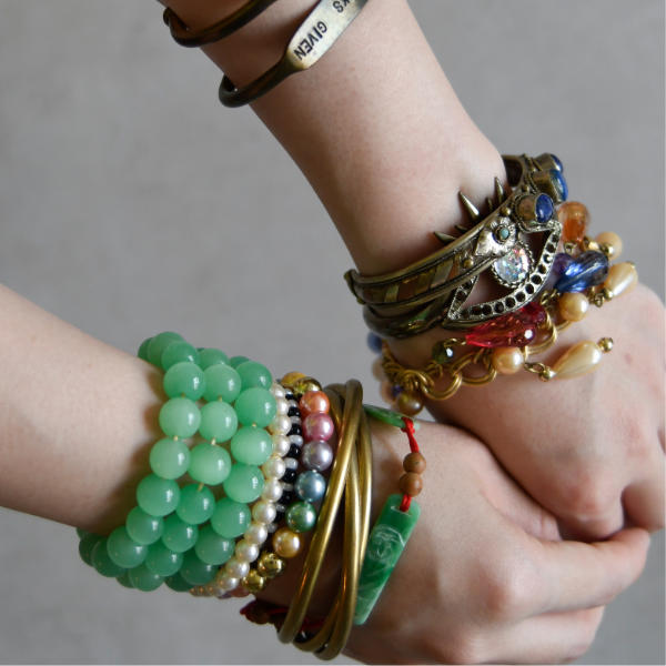 Woman wearing lots of different bracelets